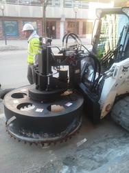 The HS-57 is a heavy-duty skid steer attachment that removes the collar and surrounding area of concrete and asphalt encasing manhole covers.